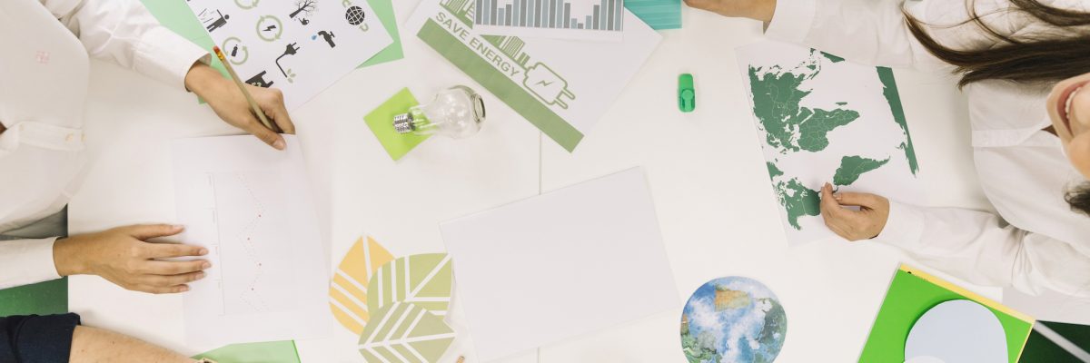 businesspeople-working-on-graph-with-various-natural-resources-icon-on-desk-3